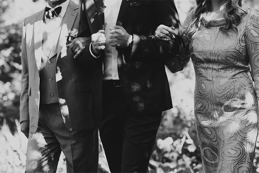 mom and dad walk groom down aisle